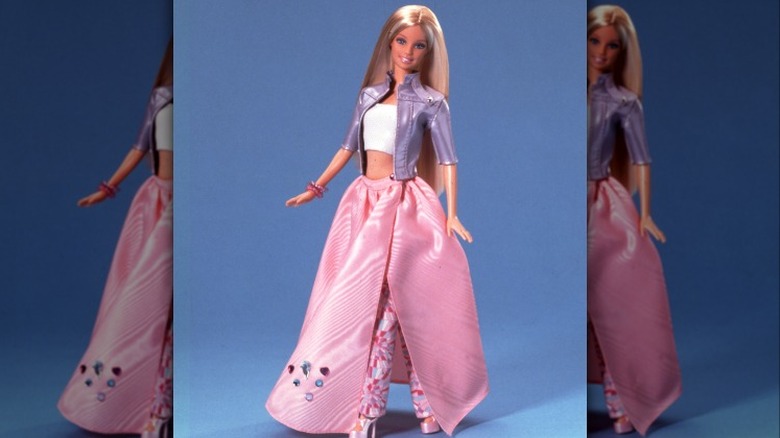 Blond Barbie wearing purple jacket and pink skirt