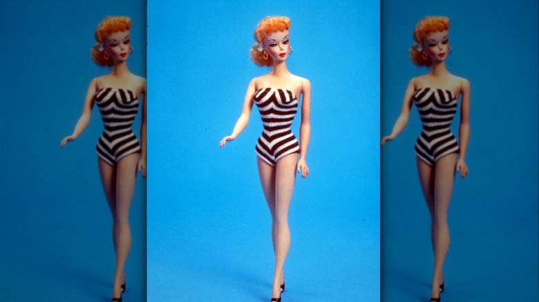 Vintage Barbie doll against blue background