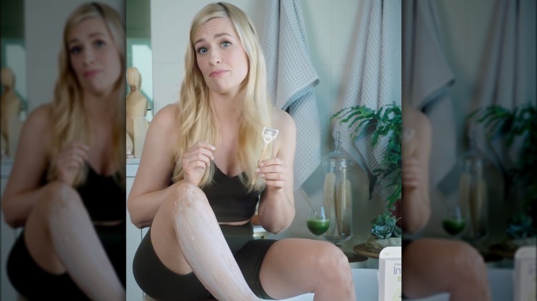Beth Behrs holds a razor