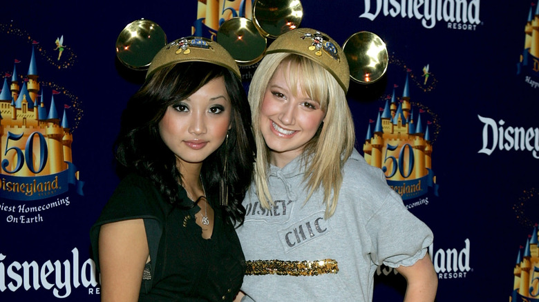 Young Ashley Tisdale and Brenda Song posing at Disneyland