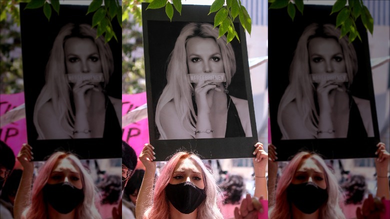 Fan holds up a poster of Britney Spears at a #FreeBritney protest