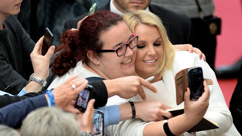 Britney Spears taking a selfie with a fan