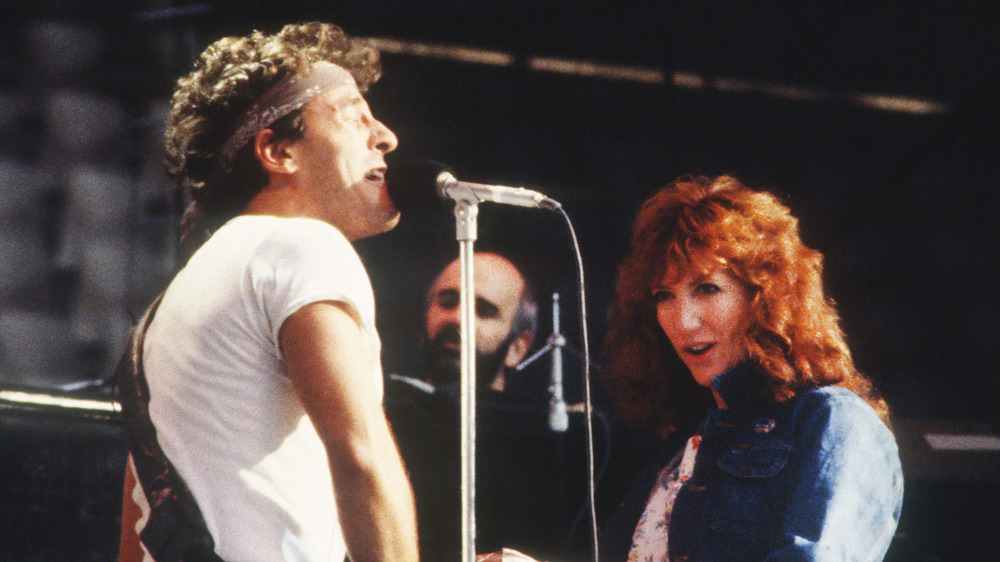 Bruce Springsteen and Patti Scialfa onstage singing