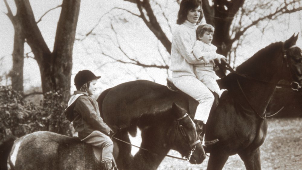 Caroline Kennedy as a girl riding horses with her family