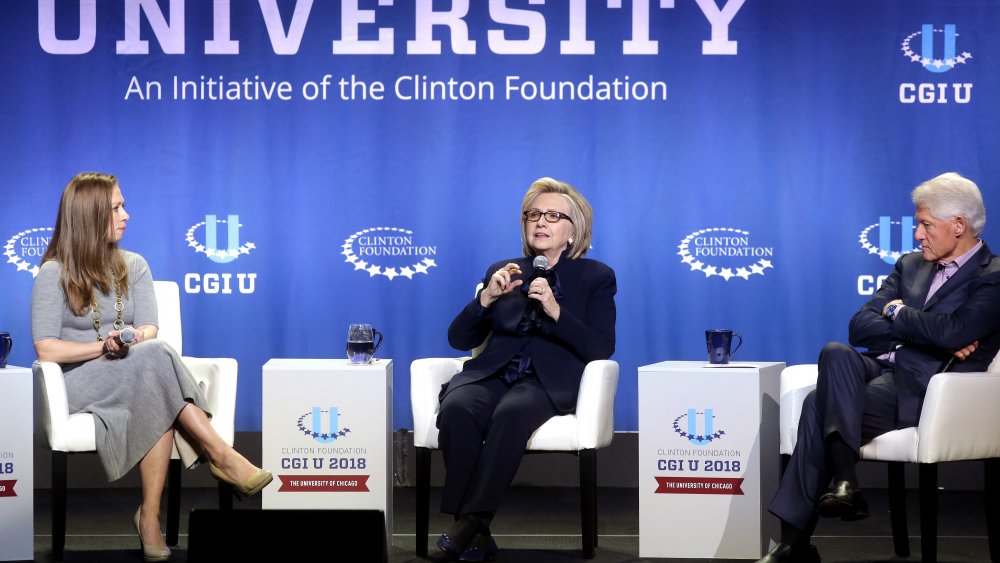 Chelsea Clinton and her parents at a forum in 2018