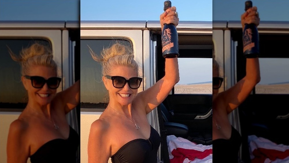 Christie Brinkley holding wine