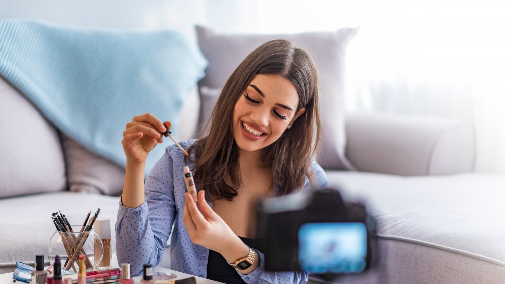 Woman demonstrates clean beauty regimen on camera