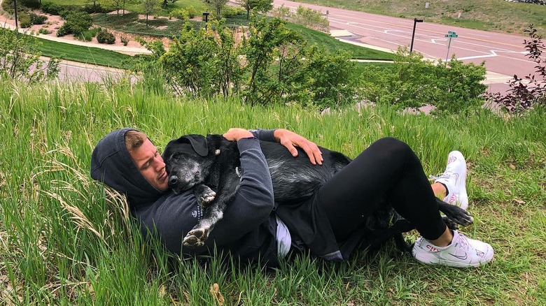 Colton Underwood hugging his dog Sniper