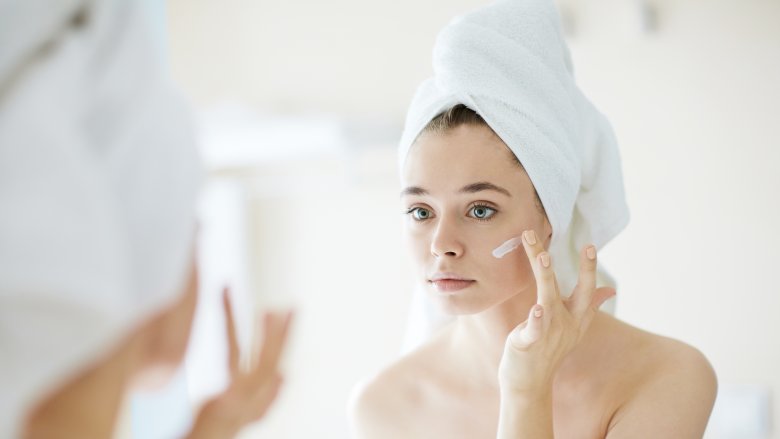 Woman applying face cream