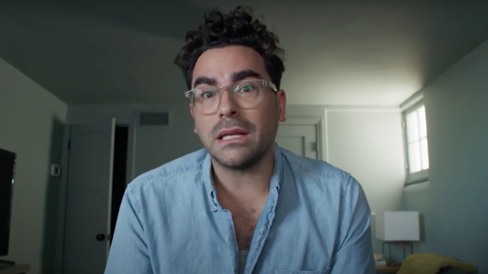 Dan Levy wearing a blue shirt