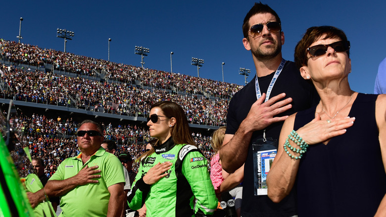 Danica Patrick with her parents and boyfriend Aaron Rodgers