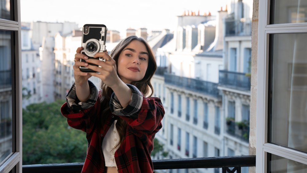 Lily Collins taking a selfie in Emily in Paris