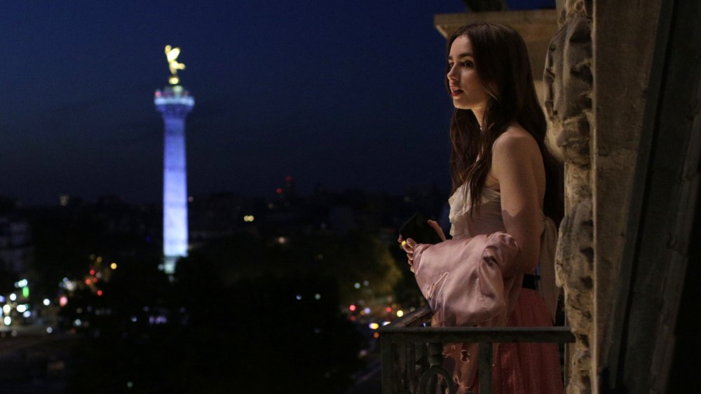 Lily Collins in Emily in Paris, looking out of a window