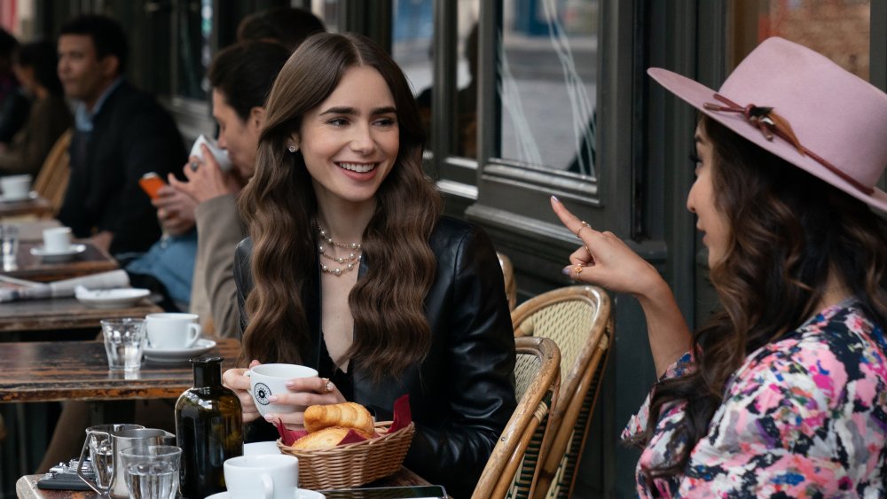 Lily Collins in Emily in Paris at a cafe