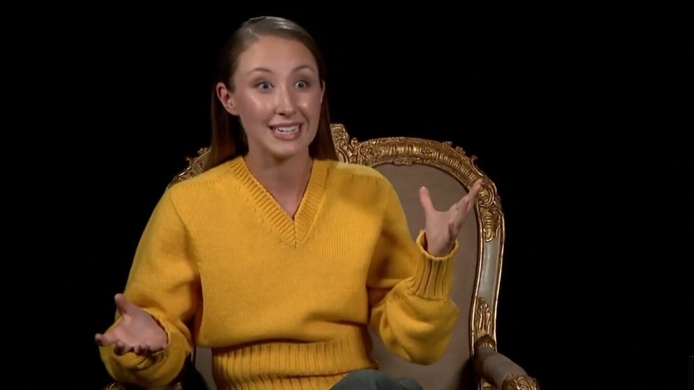 Erin Doherty wearing a yellow sweater