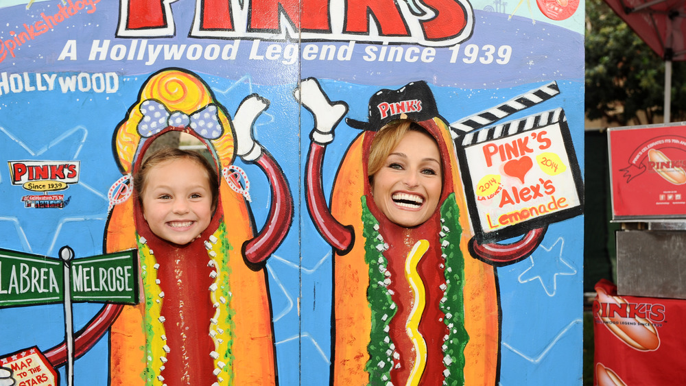 Giada De Laurentiis and Jade Thompson in hot dog cutouts