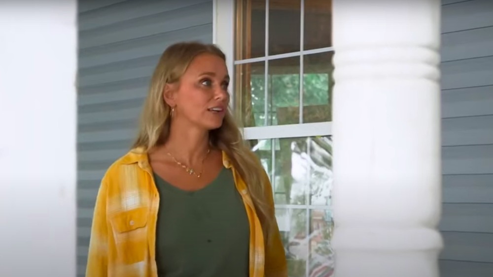 Tamara Day on a porch in Bargain Mansions