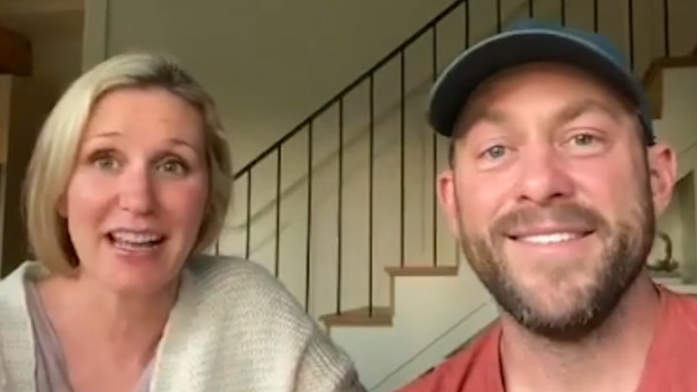 Jenny and Dave Marrs in front of a staircase on Fixer to Fabulous