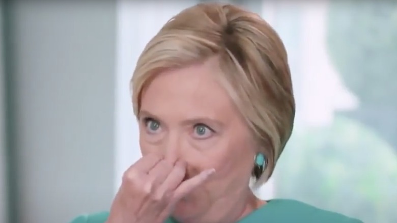 Hillary Clinton holding her nose