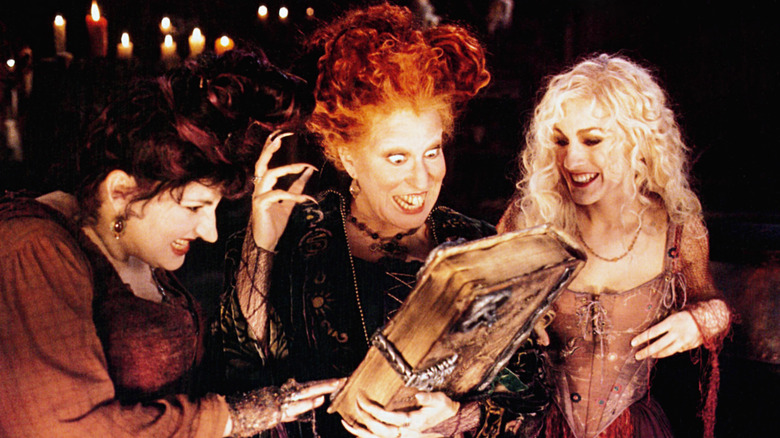 Kathy Najimy, Bette Midler, and Sarah Jessica Parker with a book in Hocus Pocus