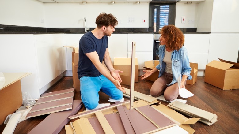 couple assembling furniture