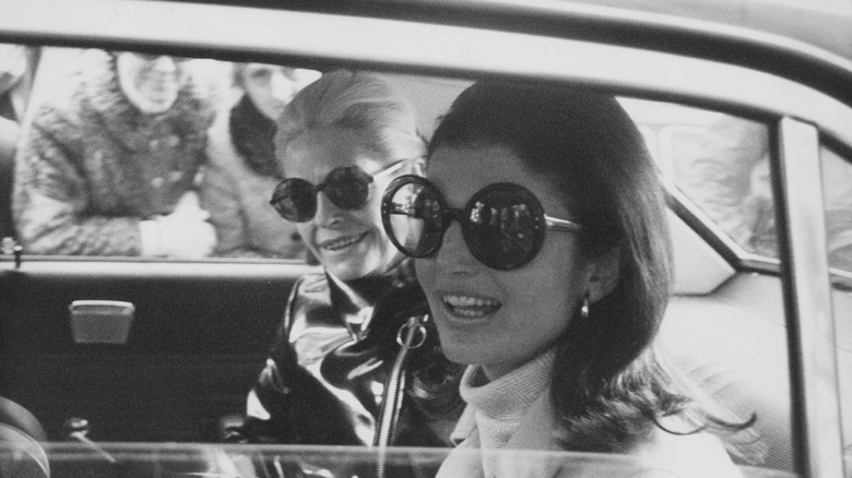 Jackie Kennedy Onassis in a car with a friend