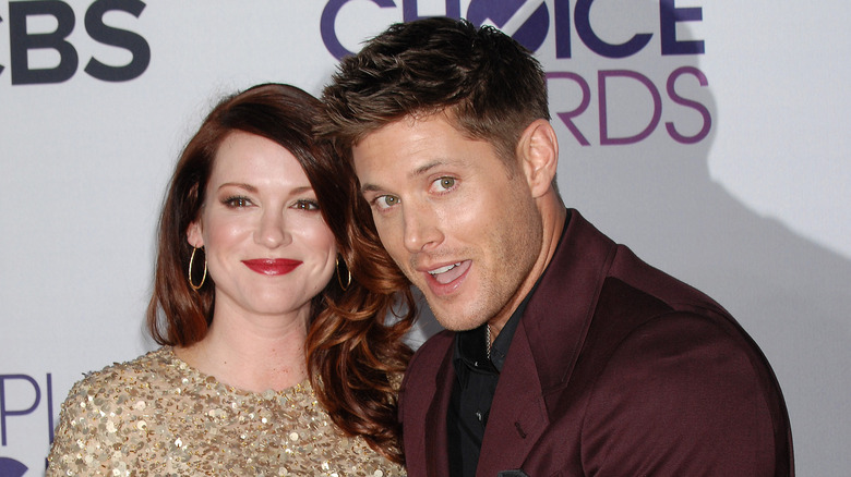 Jensen Ackles in maroon suit with Danneel Ackles