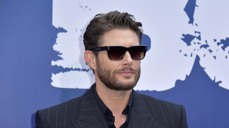 Jensen Ackles in wayfarers and black suit