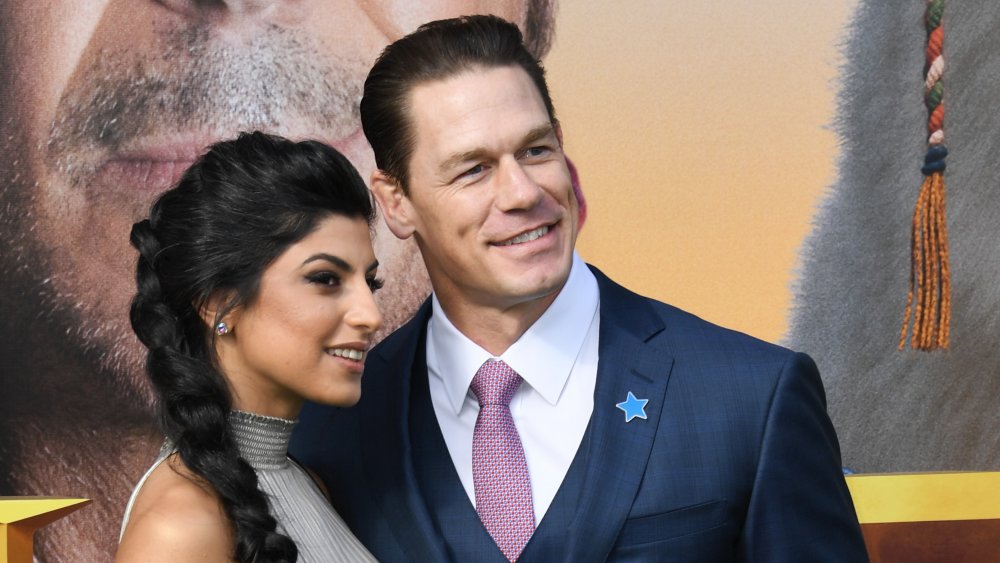 John Cena and wife Shay Shariatzadeh looking away from the camera