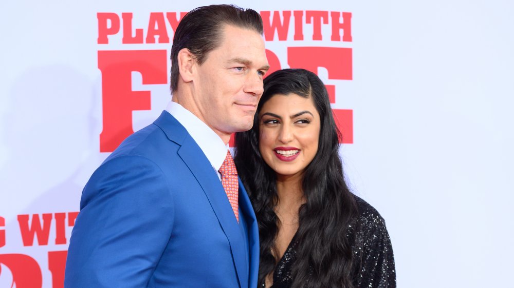 John Cena and wife Shay Shariatzadeh at a movie premiere, looking left