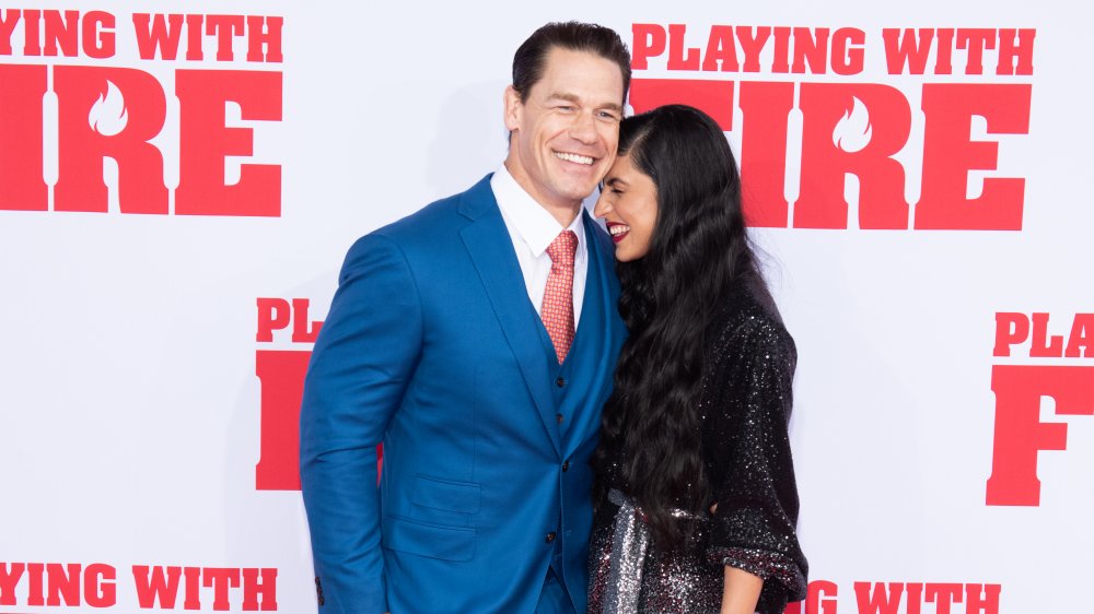 John Cena and wife Shay Shariatzadeh at a premiere, grinning