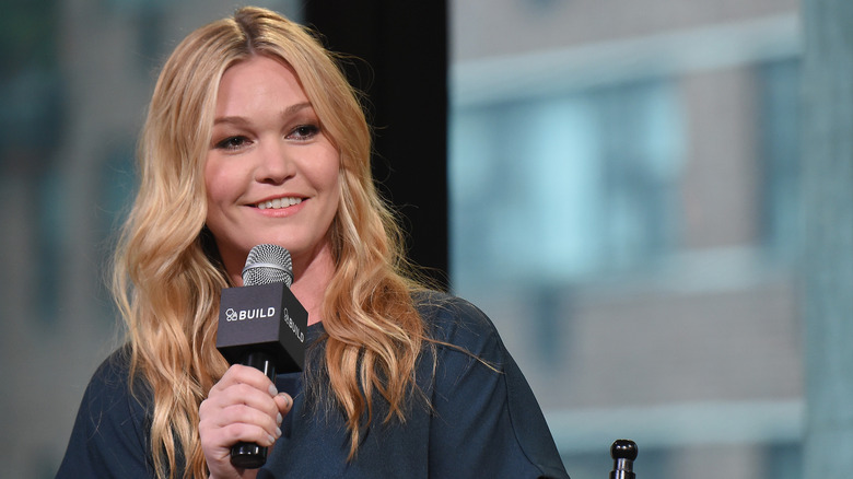 Julia Stiles holding a microphone