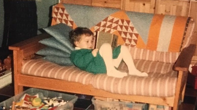 Kat Dennings reading a book as a child