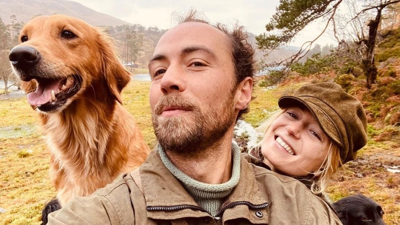 James Middleton and his wife take a pic with their dogs