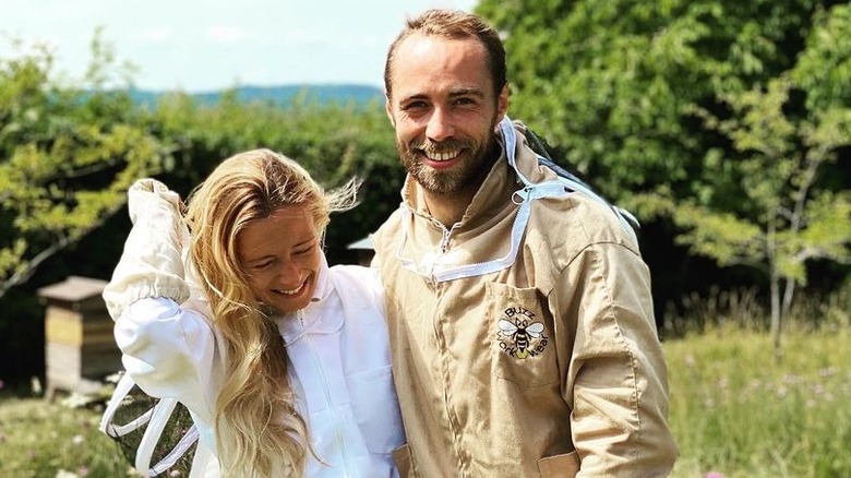 James Middleton and his wife pose with their beehives