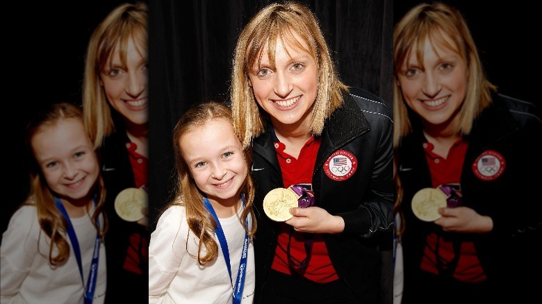Katie Ledecky embracing a young fan