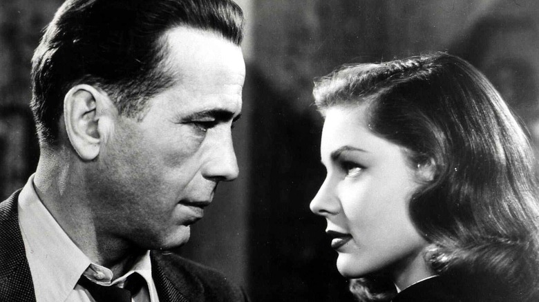 Humphrey Bogart and Lauren Bacall looking at each other