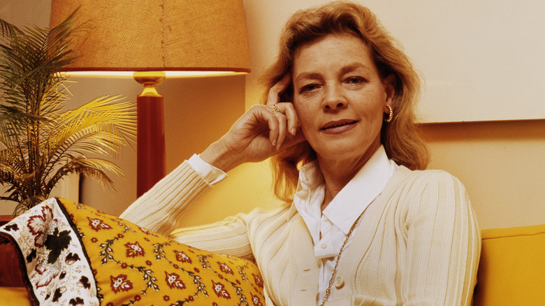 Lauren Bacall posing on a sofa