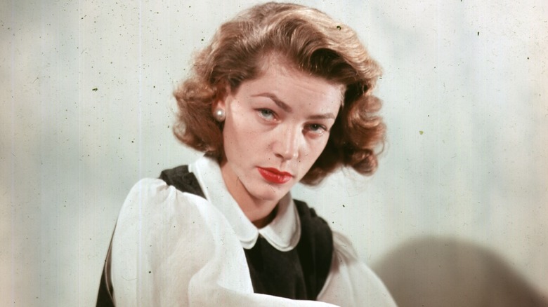 Lauren Bacall posing with a red lip