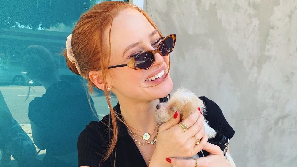 Madelaine Petsch cuddling her dog