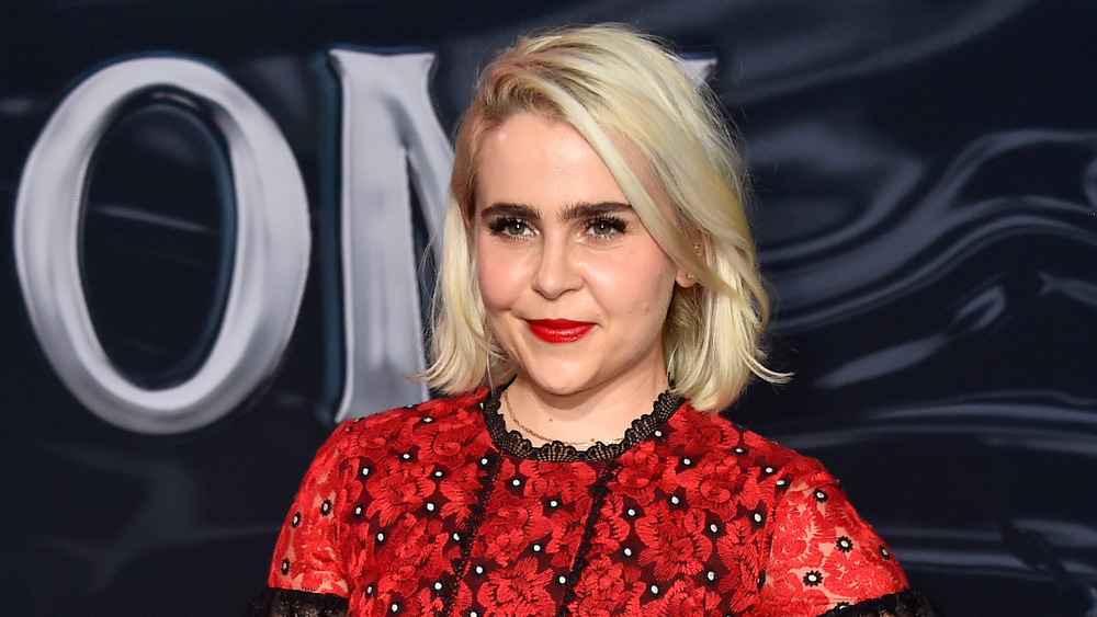 Mae Whitman smiling, wearing a red top