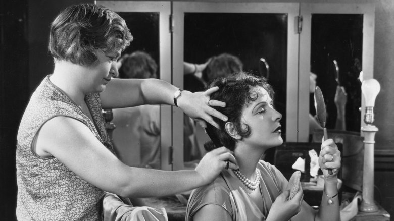 Woman applying makeup circa 1930s