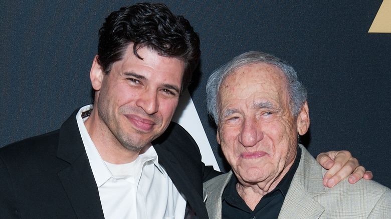 Mel Brooks and Max Brooks smiling on red carpet