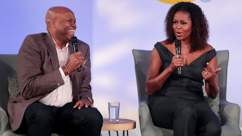 Craig Robinson and Michelle Obama speaking on stage 