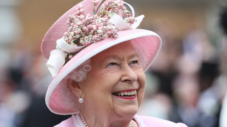 Queen Elizabeth laughing at an event