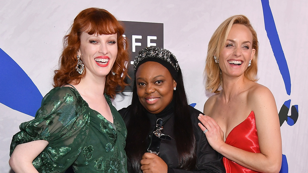 Pat McGrath posing with two models