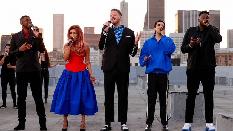 Pentatonix singing on a rooftop