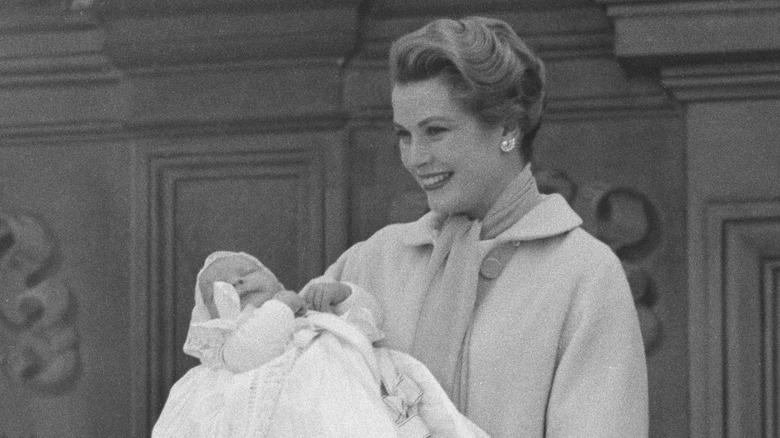 Prince Albert being held by Grace Kelly