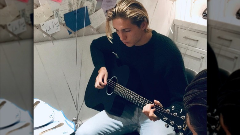 Prince Constantine Alexios playing guitar