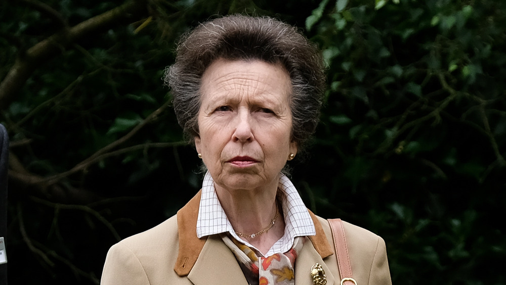 Princess Anne in front of greenery